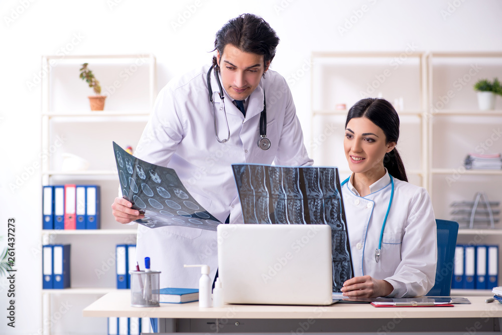 Fototapeta premium Two young doctors working in the clinic 