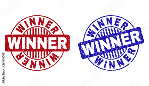 Grunge WINNER round stamp seals isolated on a white background. Round seals with grunge texture in red and blue colors. Vector rubber watermark of WINNER tag inside circle form with stripes.