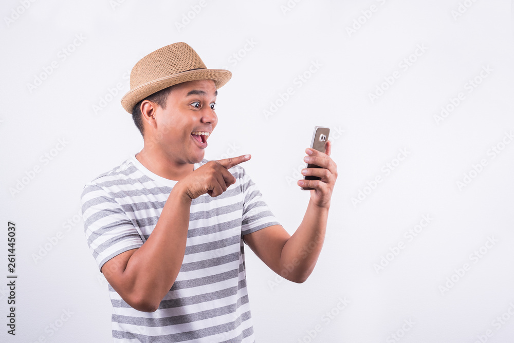 Surprised and shocked asian man looking smartphone Surprised and shocked asian man looking smartphone