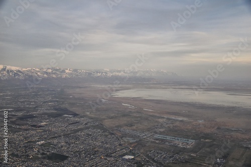 Aerial view from airplane of Antelope Island at sunset, view from Magna, sweeping cloudscape at sunrise with the Great Salt Lake State Park in winter. USA, Utah.