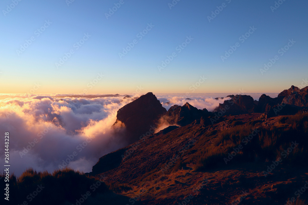 Sunset in the clouds at the height of the Pico do Arieiro on the island of Madeira. Portugal. Background, outdoors, nobody, horizontal. Concept of natural beauty.
