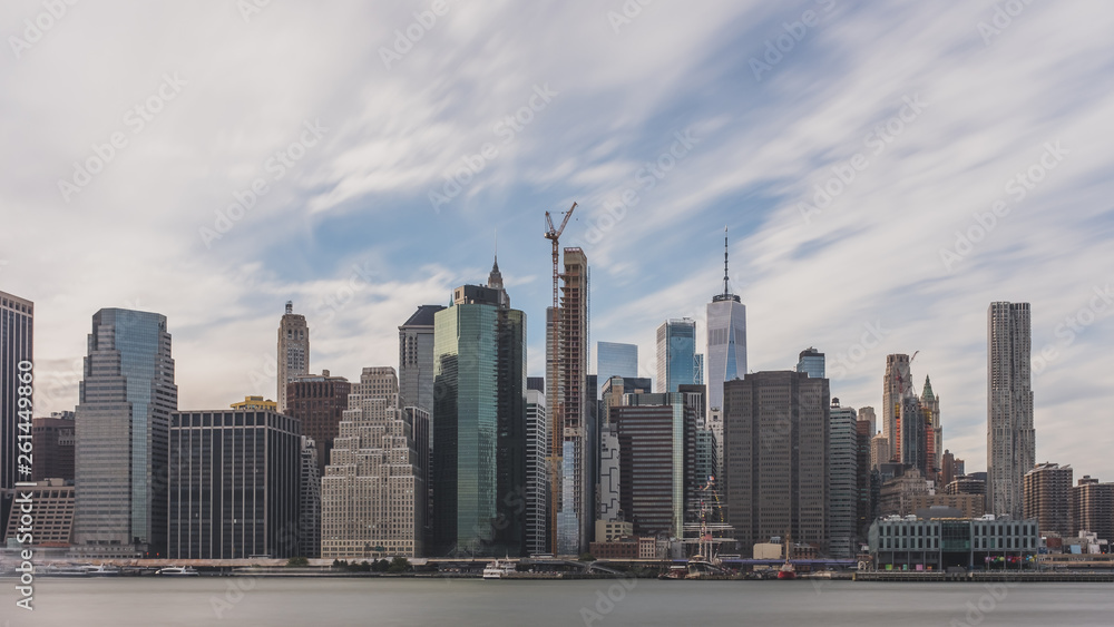 Fototapeta premium Skyscrapers of downtown Manhattan over East River, viewed from Brooklyn Bridge Park, in Brooklyn, New York, USA