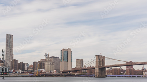 Brooklyn Bridge over East River with skyline of Manhattan, in New York, USA