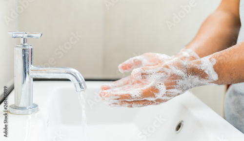фотографія Man washing hands with soap.
