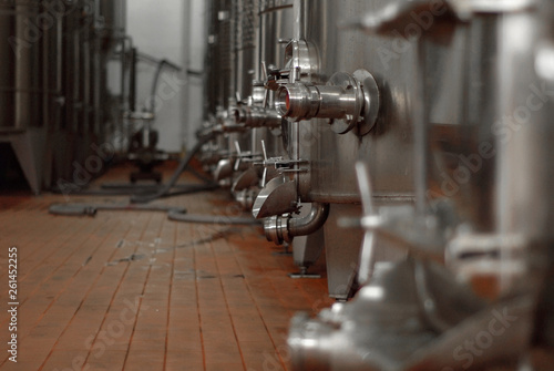 Premises of the winemaking factory. Metal parts of the equipment. Large metal barrels for wine.