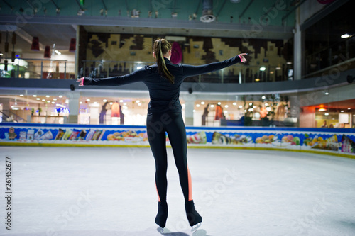 Figure skater woman at ice skating rink.
