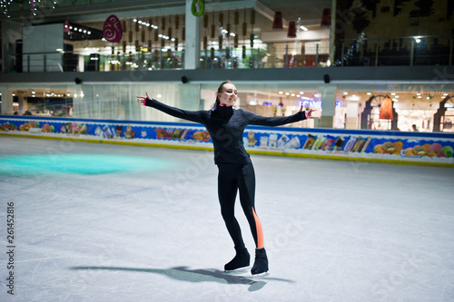 Figure skater woman at ice skating rink.