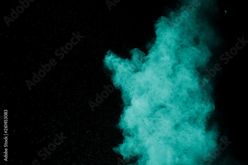 Green red color powder explosion cloud on black background.Green red dust splash on dark background.