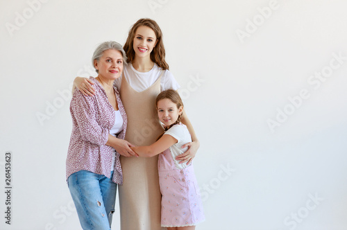 family three generations grandmother, mother and child on white background