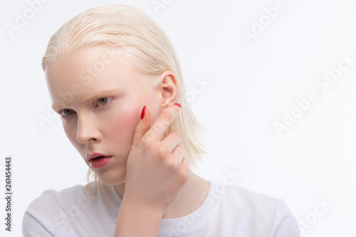 Blonde-haired young woman with white skin feeling serious
