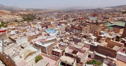 FEZ, MOROCCO. Medieval traditional architecture of the Old Fez. Aerial 4K footage of a car-free urban area with narrow alleyways.