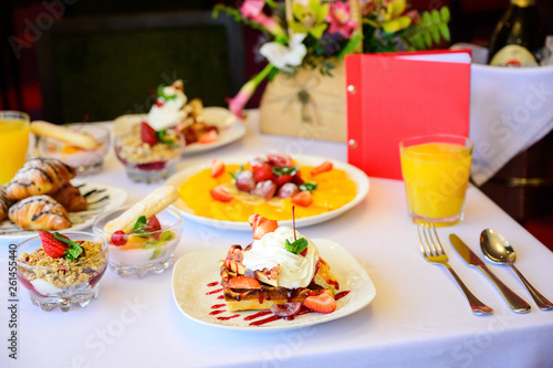 Dessert with croissants, ice cream and sliced fruit