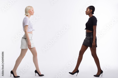 Women with different skin color stepping towards each other