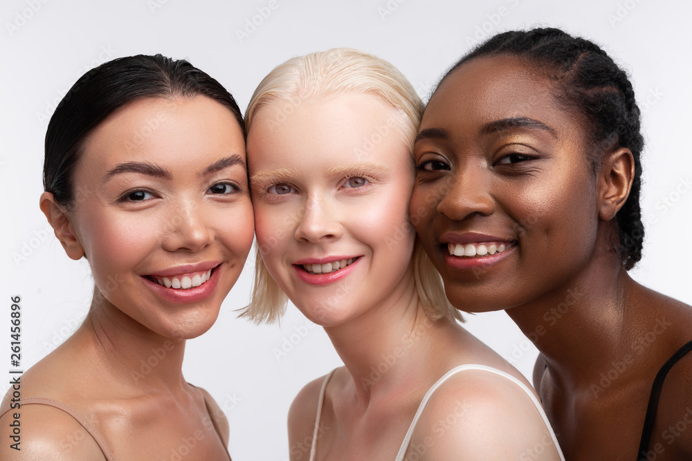 Three women smiling while thinking about women power Three women smiling while thinking about women power
