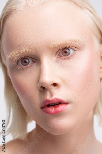 Grey-eyed woman with white skin having strange face expression