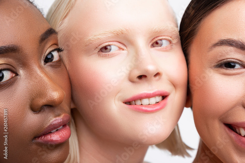 Grey-eyed women with light eyebrows standing between friends
