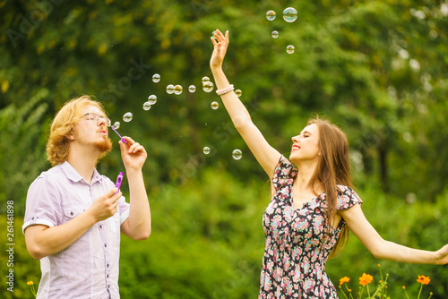 Couple blowing bubbles outdoor