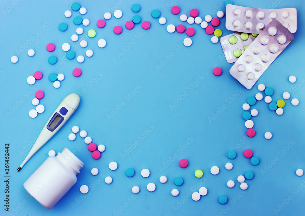 Multi-colored pills on a blue background Multi-colored pills on a blue background