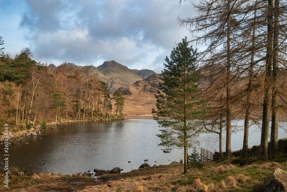 Beautiful vibrant sunrise landscape image of Blea Tarn in UK Lake District with Langdales Range in background Beautiful vibrant sunrise landscape image of Blea Tarn in UK Lake District with Langdales Range in background