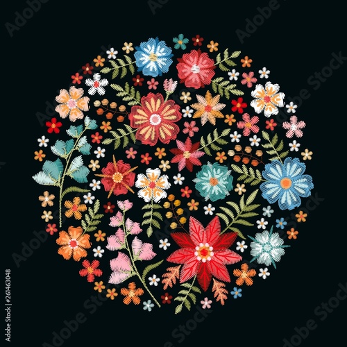 Round composition with bright embroidery flowers and leaves on black background. Fashion print.