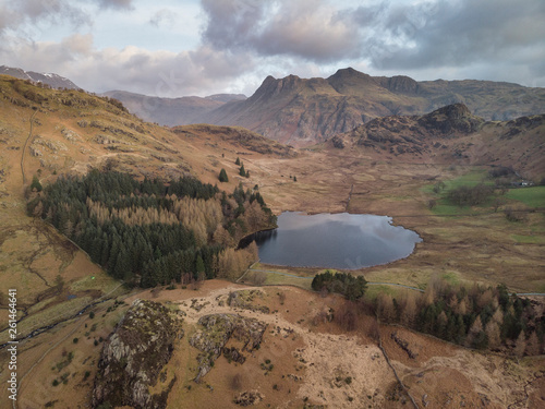 Beautiufl unique drone aerial sunrise landscape image of Blea Tarn and Langdales Range in UK Lake District