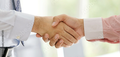 Close up of businessman handshake at office, business cooperation, success in business concept