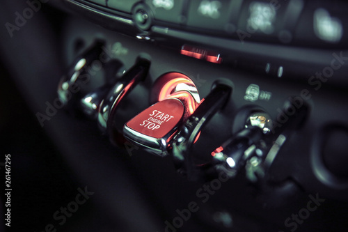 red toggle switch engine start close-up. red backlight on start engine button