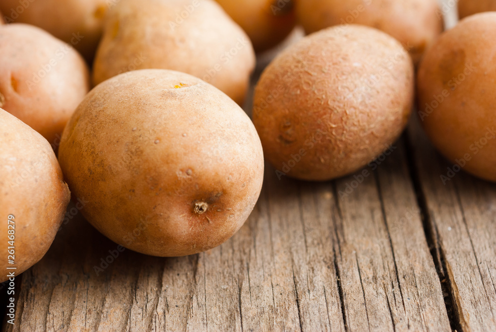 petite potatoes on rustic wood table background petite potatoes on rustic wood table background