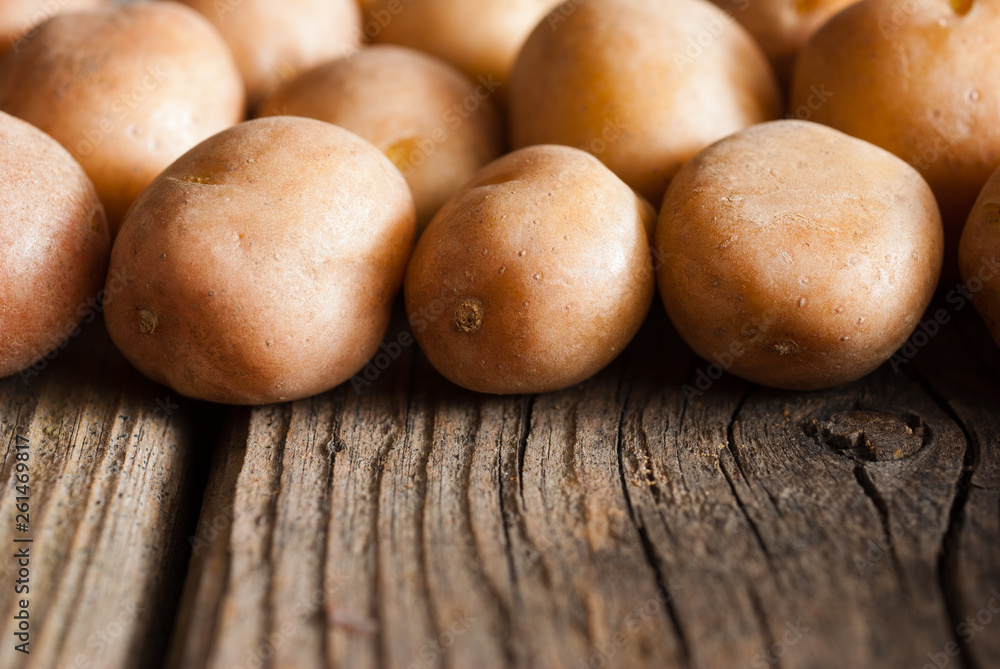 petite potatoes on rustic wood table background petite potatoes on rustic wood table background