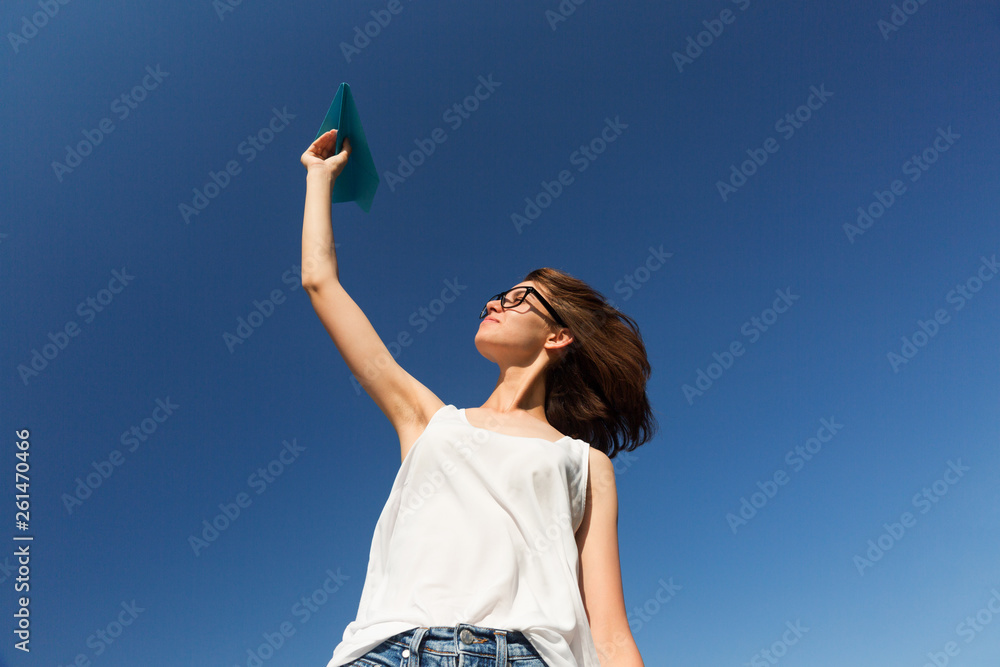 Young teenager girl is throwing a paper plane. Young teenager girl is throwing a paper plane.