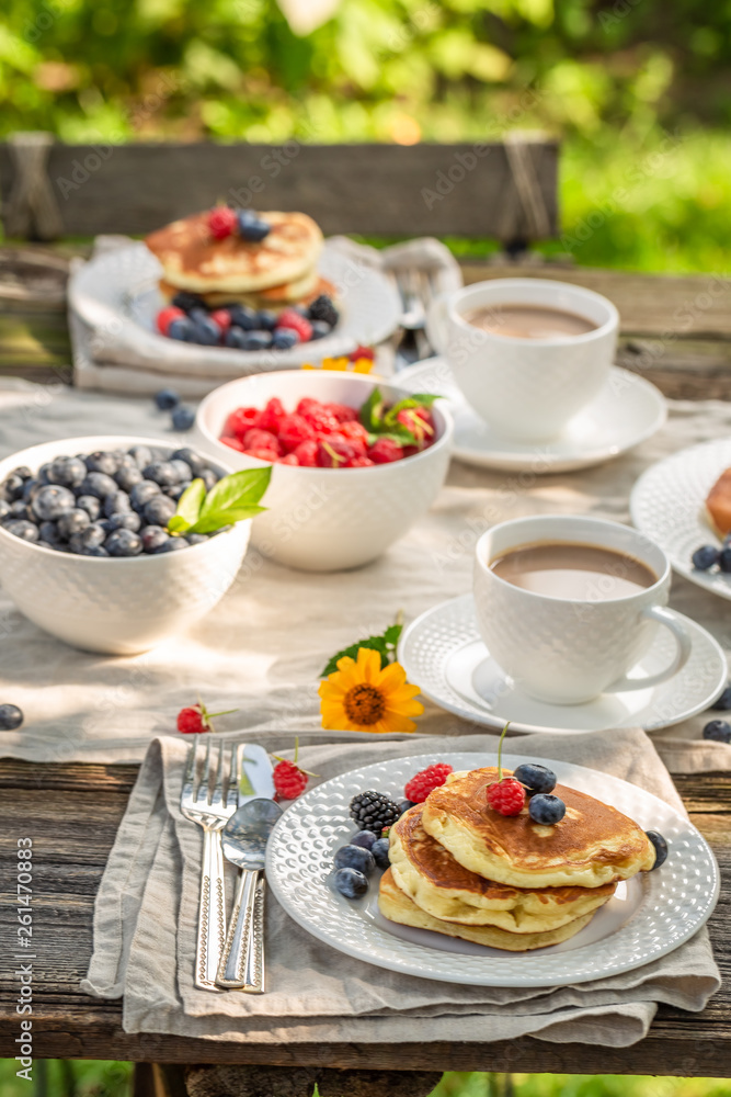 Tasty pancakes with raspberries, blueberries and honey Tasty pancakes with raspberries, blueberries and honey