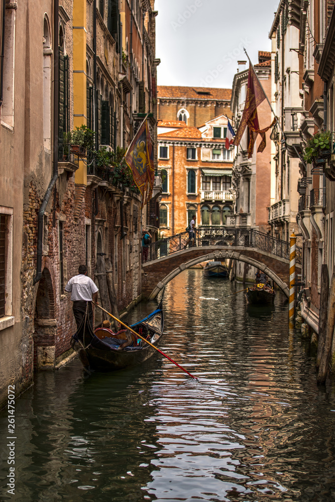 A view of Venice cityscene with gondola romantic narrow canal and bridge