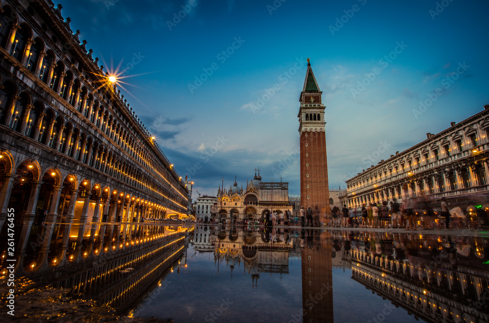 A view of St. Mark's Square with Campanile and Doge's Palace at sunset time