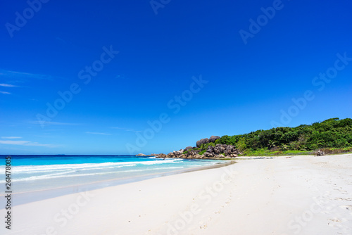 White sand  palm trees  granite rocks and turquoise water at the paradise beach at grand anse  la digue  seychelles 6