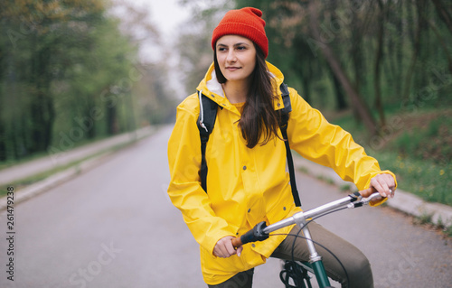 Woman riding bicycle on rain day  © yossarian6