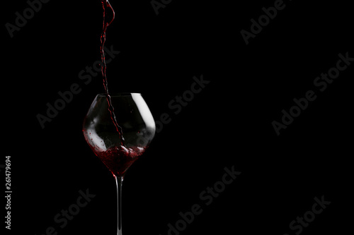 red wine pouring in glass baner. bartender on waiter concept on black background