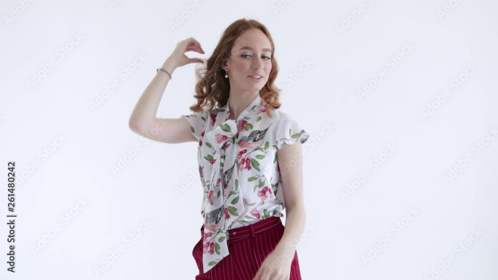 Sexy model with red hair posing on white background, slow mo Sexy model with red hair posing on white background, slow mo