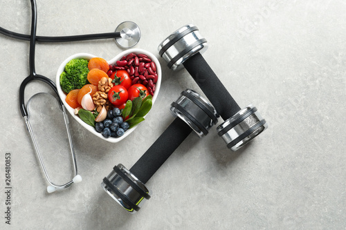 Fotografie Flat lay composition with bowl of heart-healthy diet products and space for text