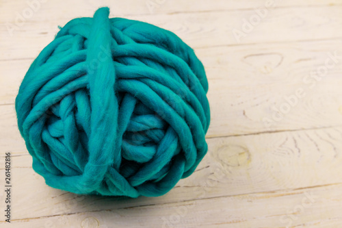 Merino wool yarn ball on white wooden background