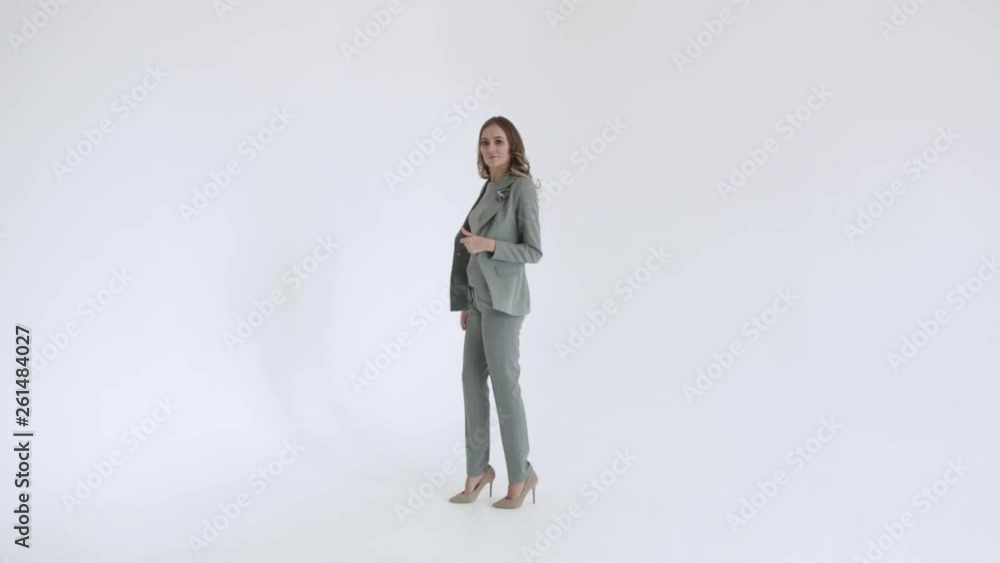Business lady posing in a gray jacket and trousers on a white background. Sexy female model, in gray suit goes ahead, 50 frames per second Business lady posing in a gray jacket and trousers on a white background. Sexy female model, in gray suit goes ahead, 50 frames per second