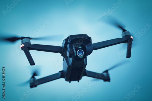 Drone in the dark blue sky leading video surveillance and shooting