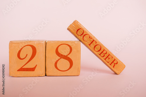 october 28th. Day 28 of month, handmade wood calendar  on modern color background. autumn month, day of the year concept photo