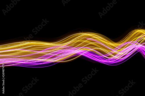 Pink and gold light painting photography, long exposure photo of fairy lights in swirls and ripples, abstract design against a black background