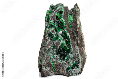 Macro stone garnet mineral, Uvarovite in rock on a white background