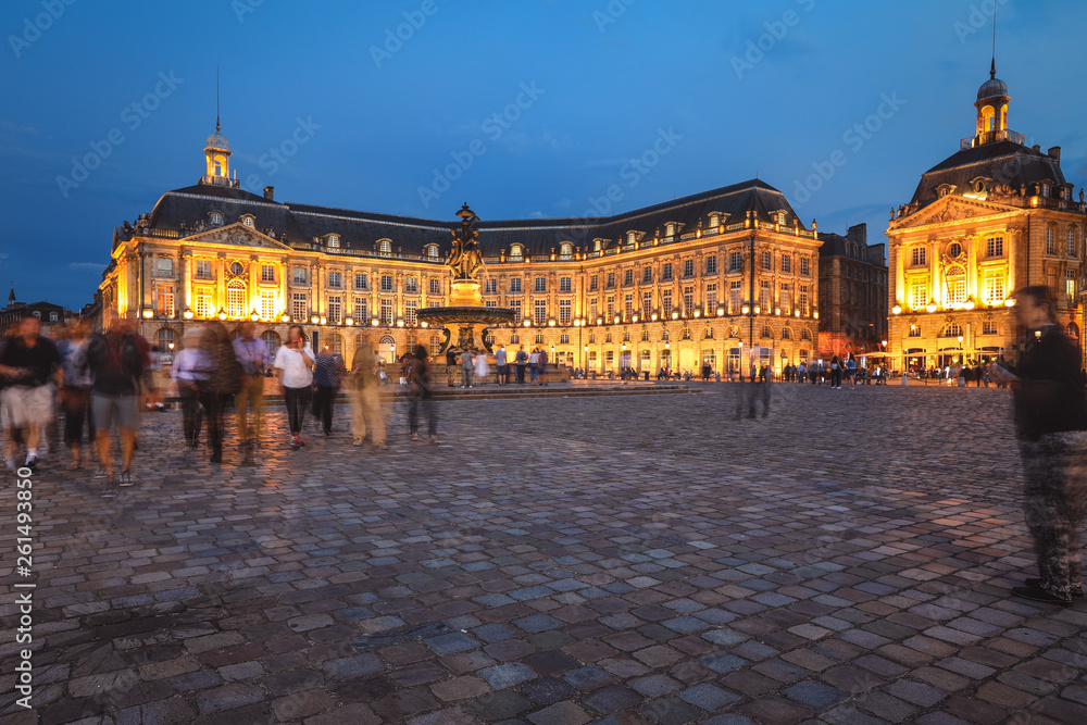 Fototapeta premium Selective focus on building, People enjoy visiting Place de la Bourse at twilight, Place de la Bourse is one of the most recognizable sights of Bordeaux, France