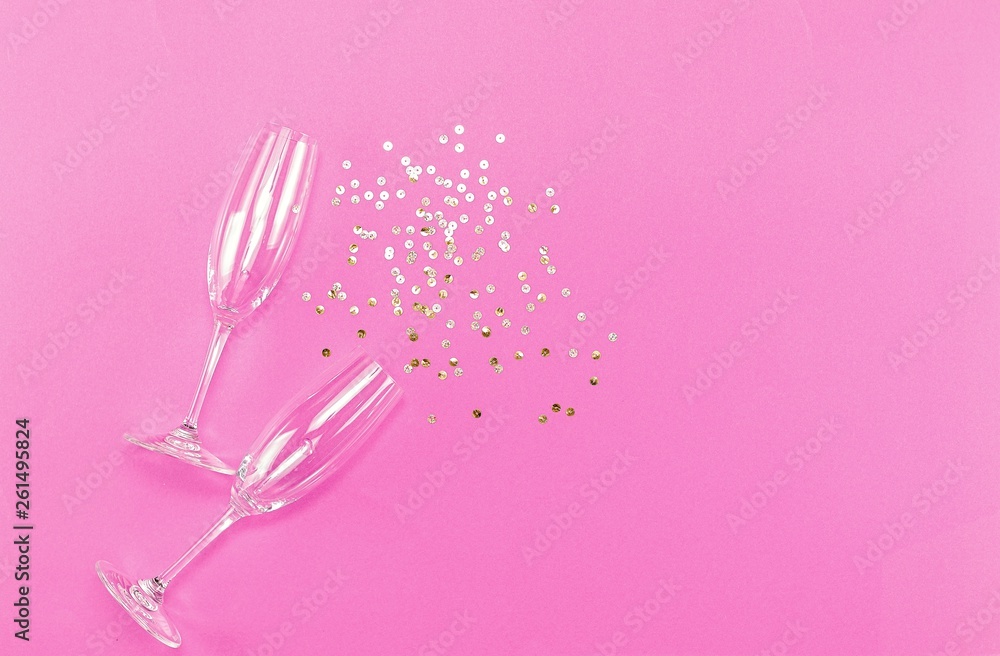 Champagne glasses with splash of golden confetti. Top view. Cele Champagne glasses with splash of golden confetti. Top view. Cele
