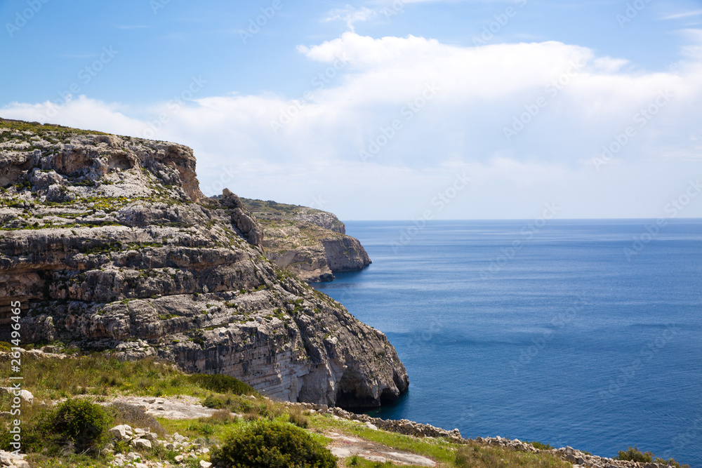 Malta rocky coastline near blue grotto. Bright sunny day, blue waters of Mediterranean sea. 