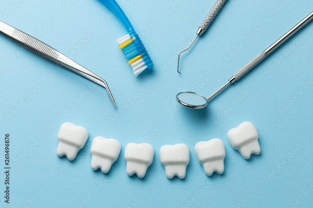 Healthy white teeth on blue background and dentist tools mirror, hook. Healthy white teeth on blue background and dentist tools mirror, hook.