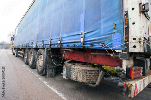 side of a blue awning truck trailer