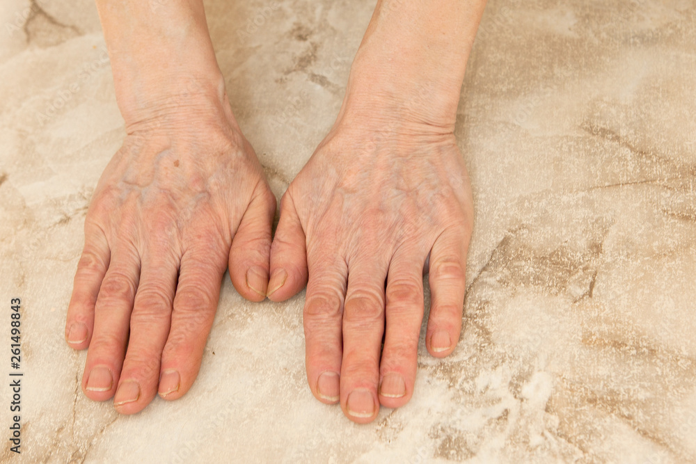 a woman's hands on a wmarble background, place for text a woman's hands on a wmarble background, place for text